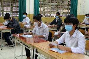 Vietnamese students taking the graduation examination in a classroom